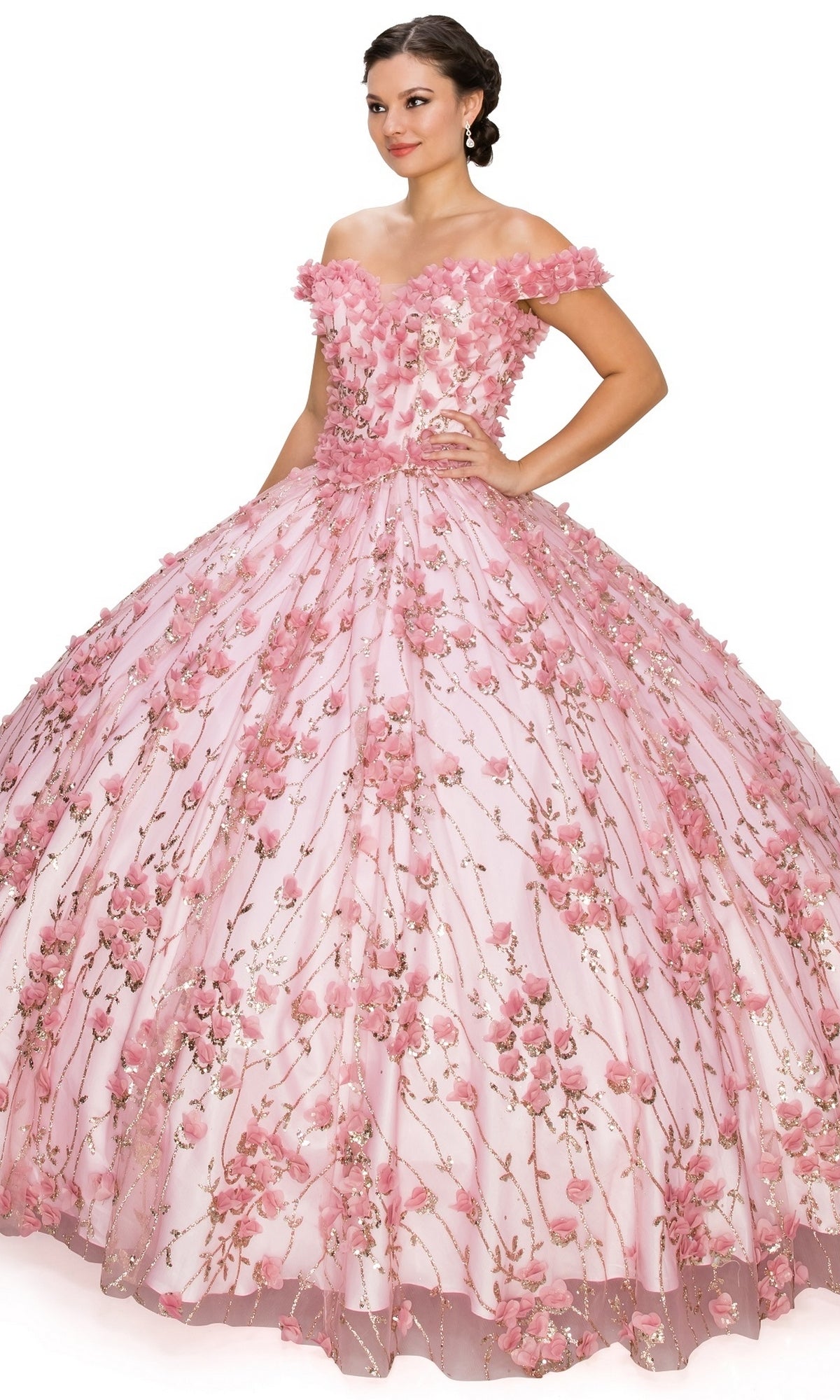 A woman stands against a white background wearing the Quinceanera Ball Gown 8021J, featuring a voluminous pink off-the-shoulder design with a lace-up corset bodice and 3D floral details.